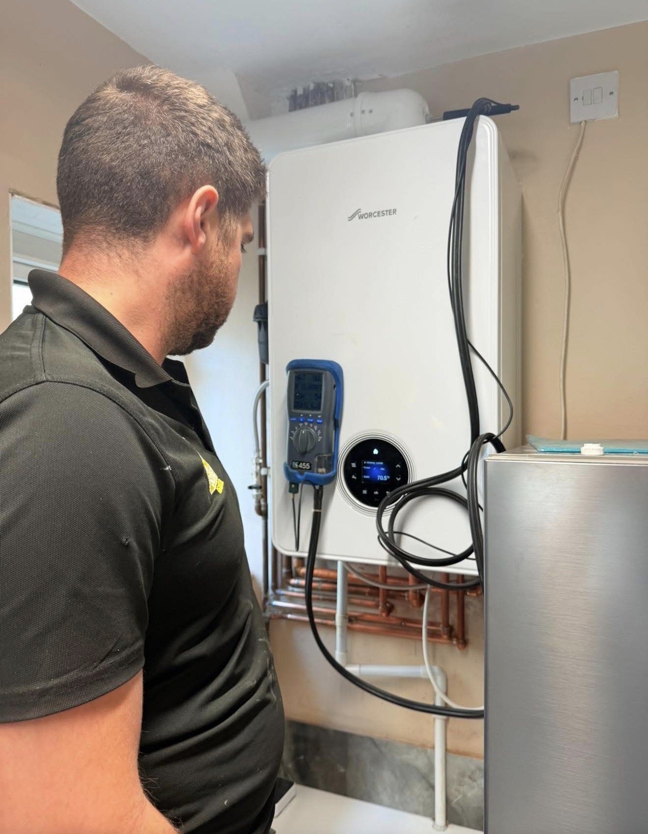 SwiftHeat engineer testing and commissioning a Worcester boiler with a professional flue-gas analyser